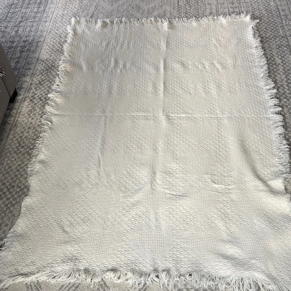 Beautiful white blanket with subtle heart detail.